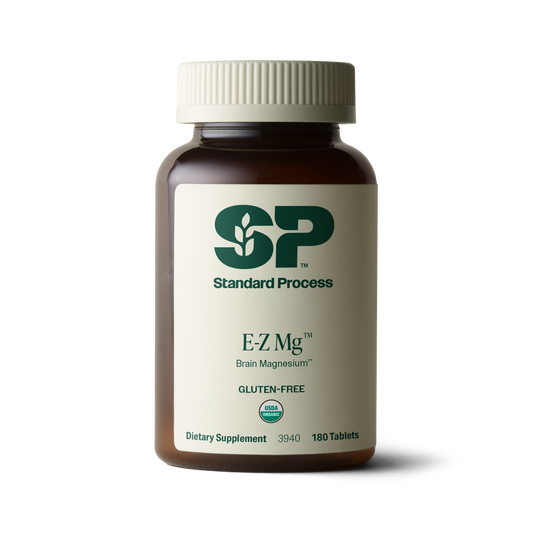 Image of E-Z Mg bottle next to tablets of magnesium supplements.